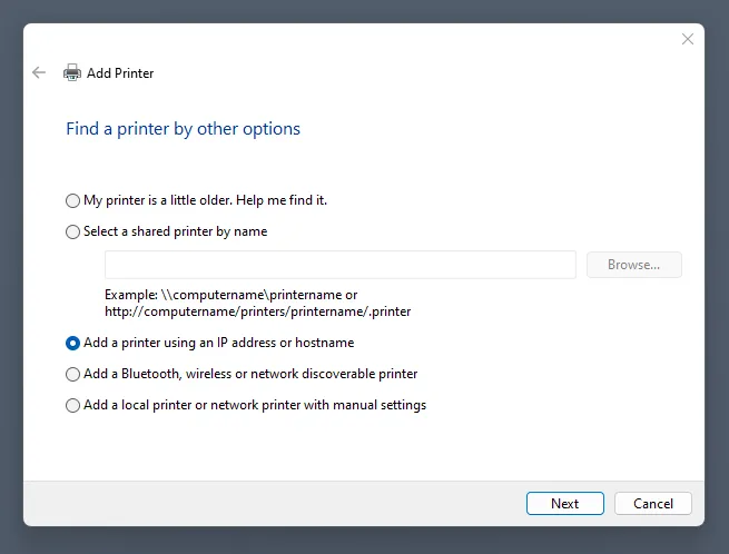 Jendela 'Add Printer' di Windows dengan opsi 'Add a printer using an IP address or hostname' dipilih.